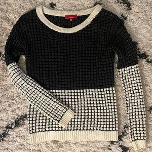 Black and white knit sweater with shiny black knit details